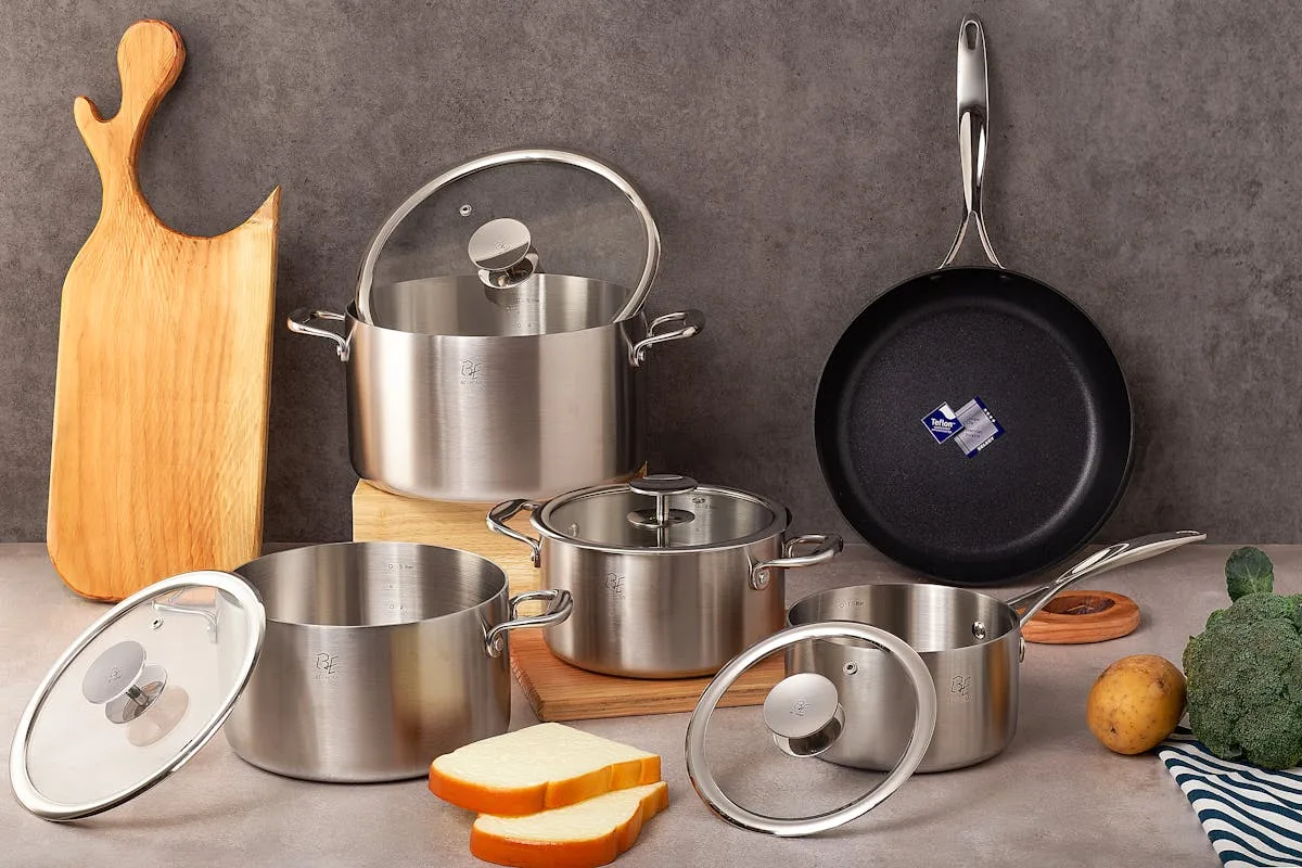 Stainless steel saucepan and cookware set on kitchen counter