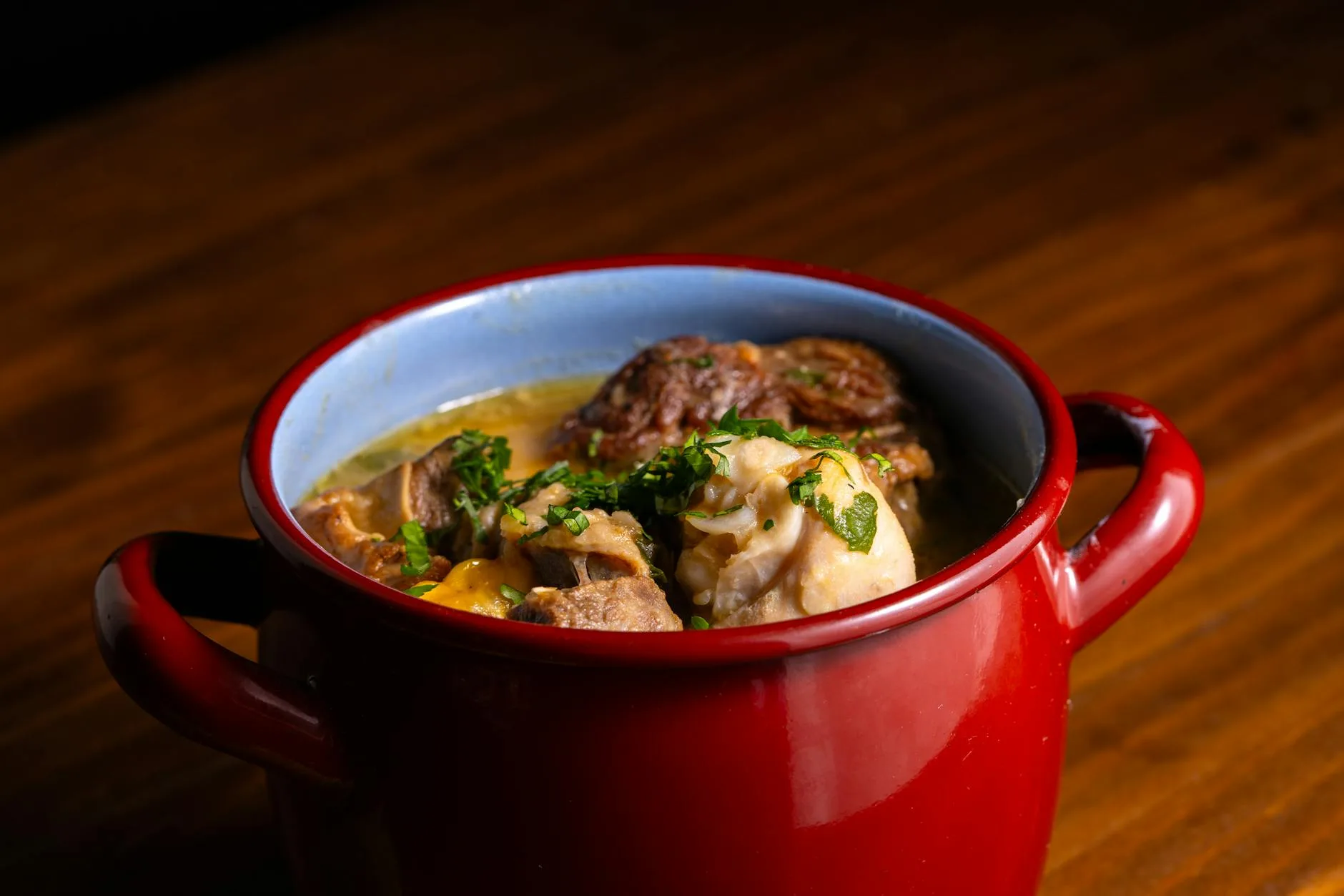 Beef stew cooking in a cast iron casserole dish