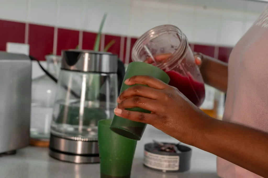 Powerful blender filled with fresh fruit on a modern kitchen worktop