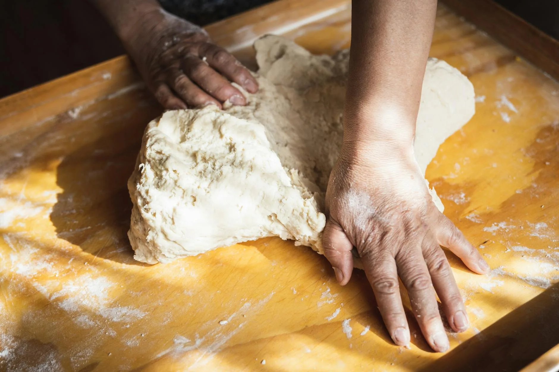Bread dough being kneaded on a floured surface