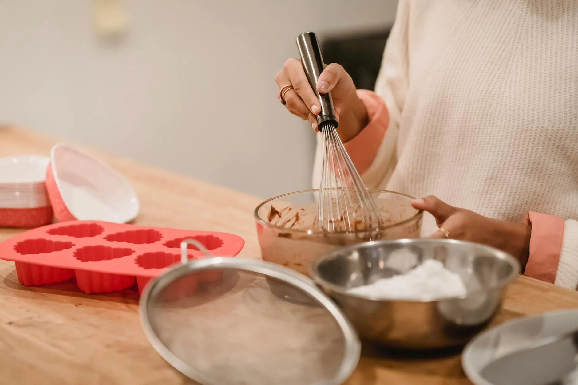 Cake batter being mixed in a bowl with a whisk