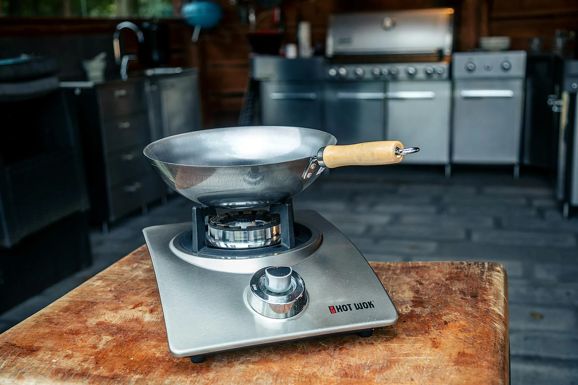 Seasoned carbon steel wok with dark patina on a kitchen counter