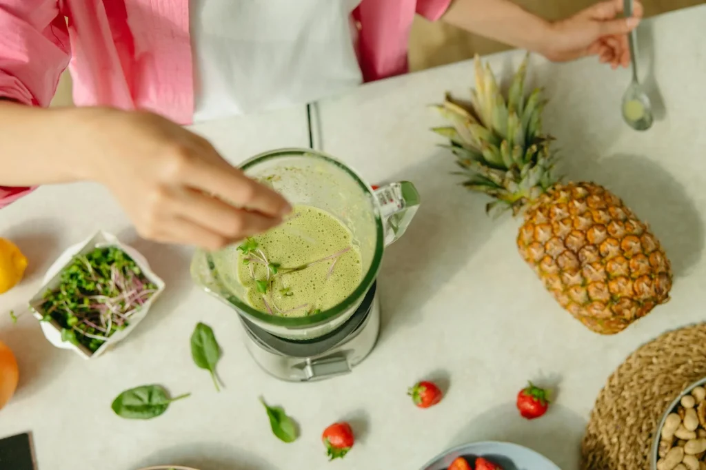 Blender filled with fresh fruit on a kitchen worktop ready to make a smoothie
