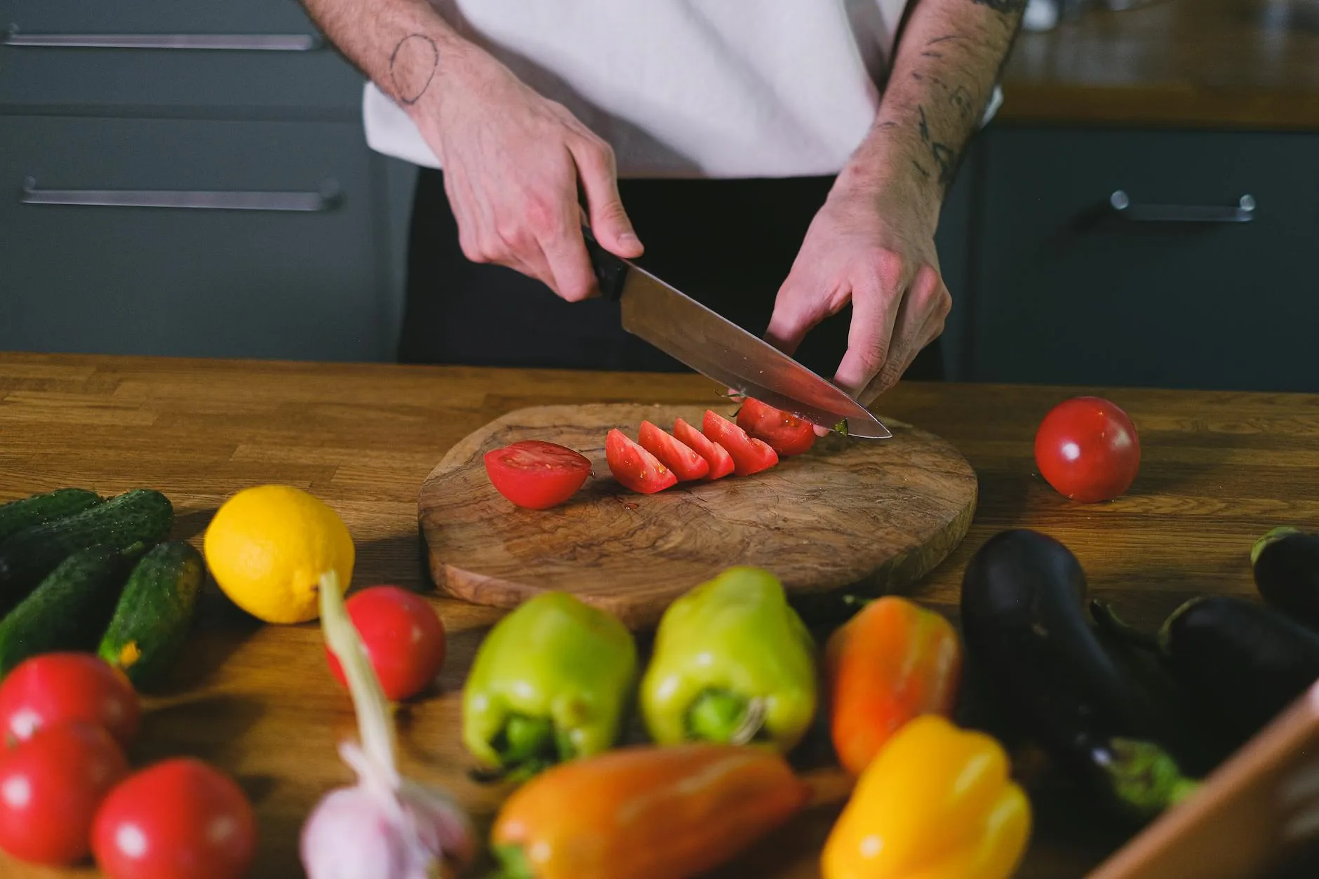 Person chopping vegetables with a chef knife in a kitchen