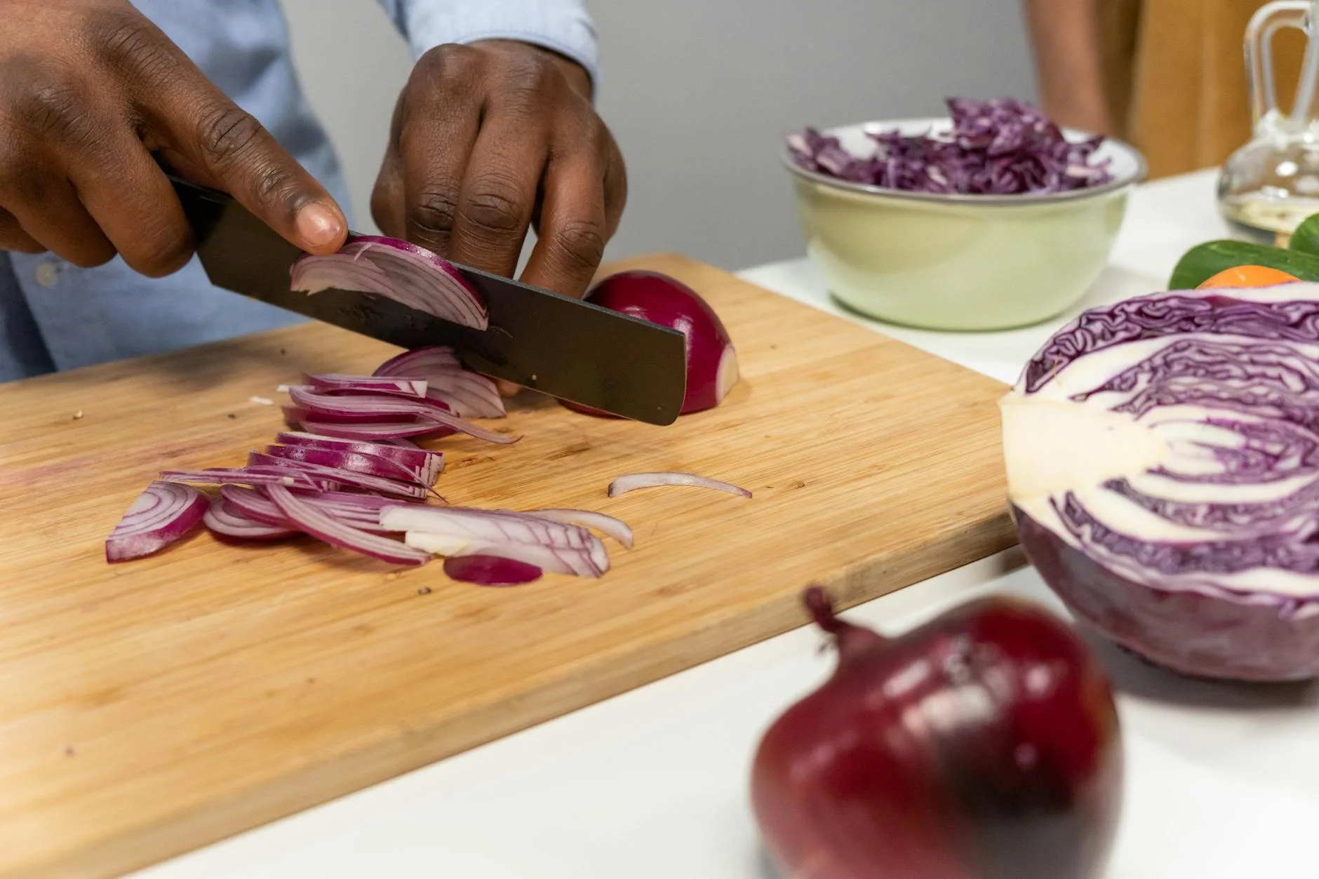 Fresh vegetables being chopped on a kitchen board
