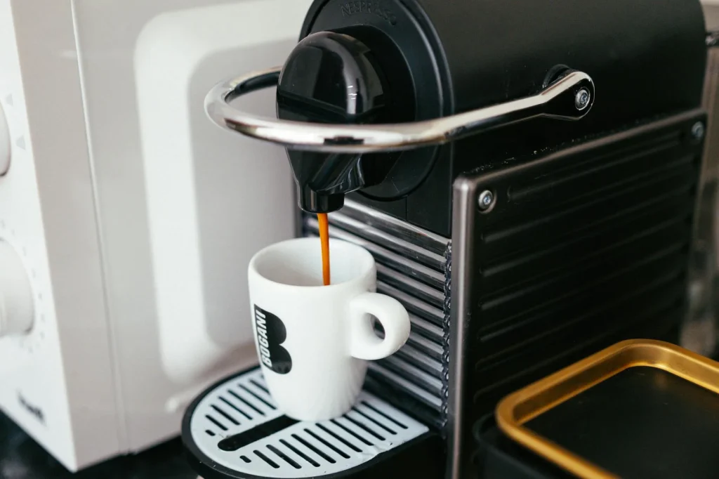 Espresso machine brewing coffee on a modern kitchen counter