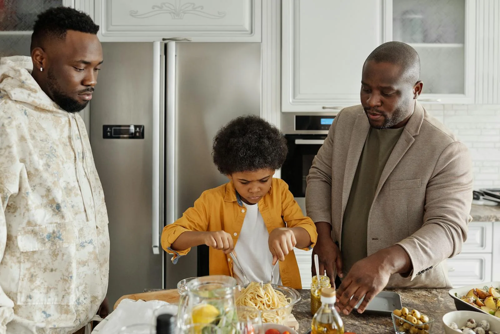 Family cooking dinner together in kitchen