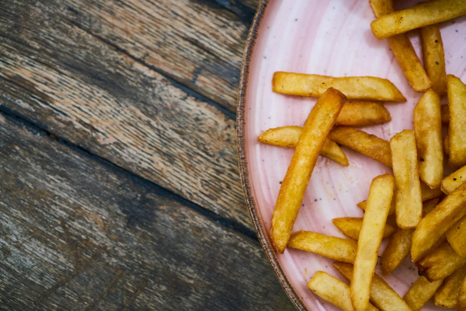 Golden crispy chips served on plate