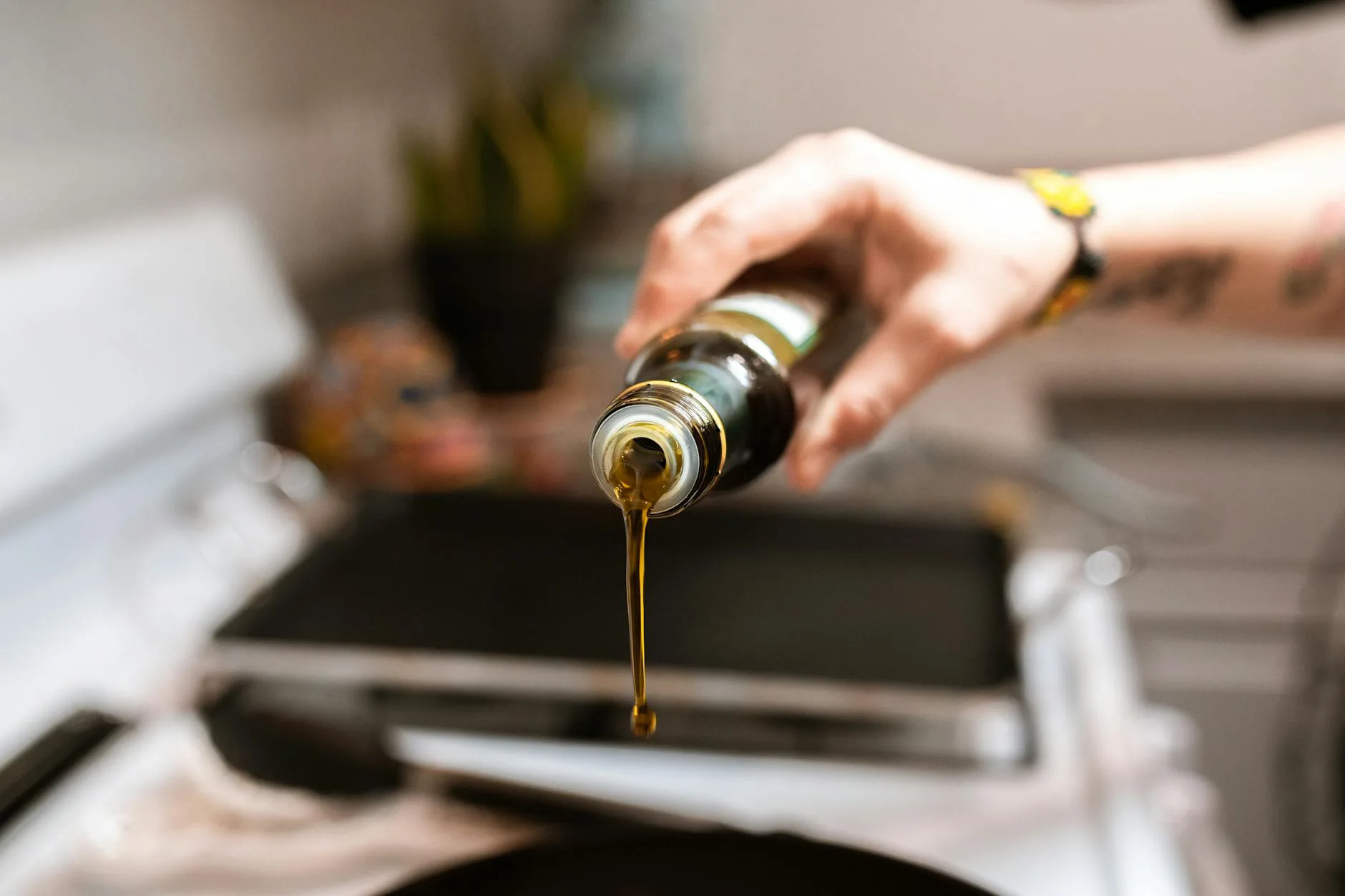 Olive oil being poured for healthy cooking with minimal fat