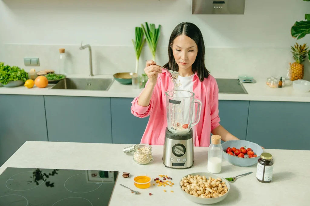 High-speed blender on a kitchen counter with fresh fruit for smoothies