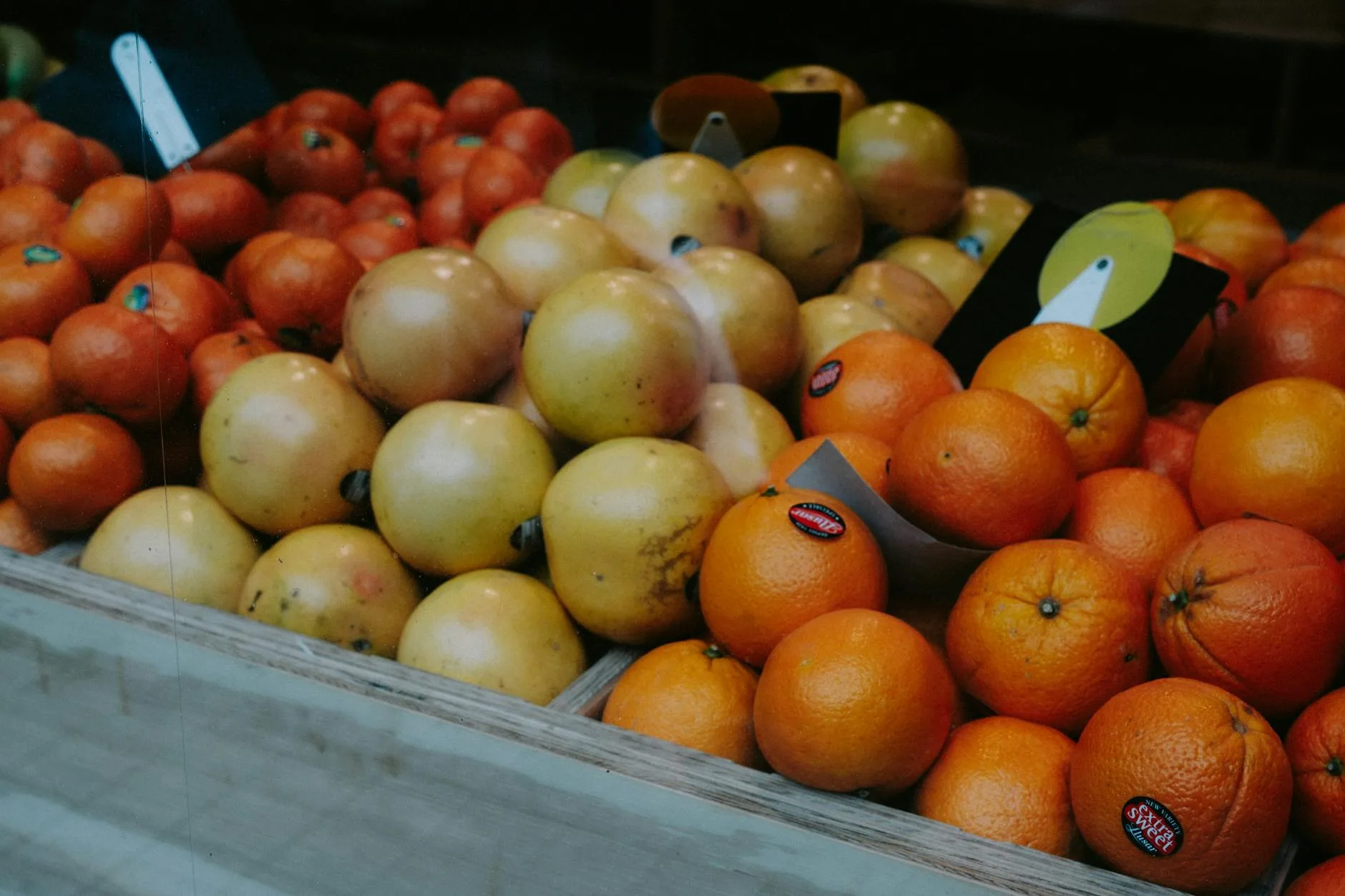 Fresh carrots oranges and apples at a market for juicing