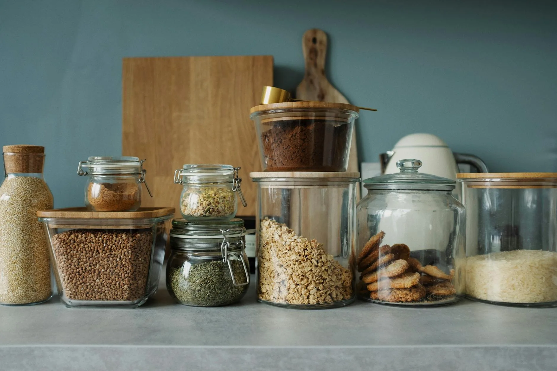 Inside of an organised kitchen cupboard with clear containers