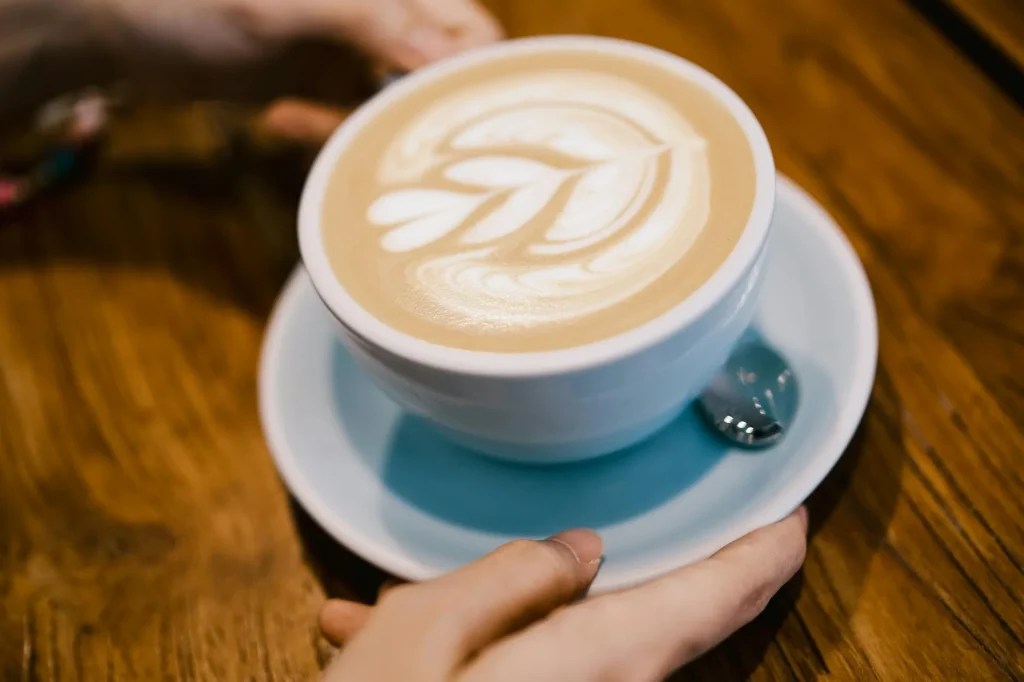 Latte with milk foam art in a white cup