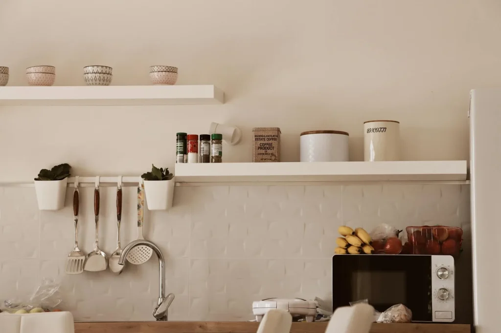 Well-organised small kitchen with tidy shelves and clear worktops