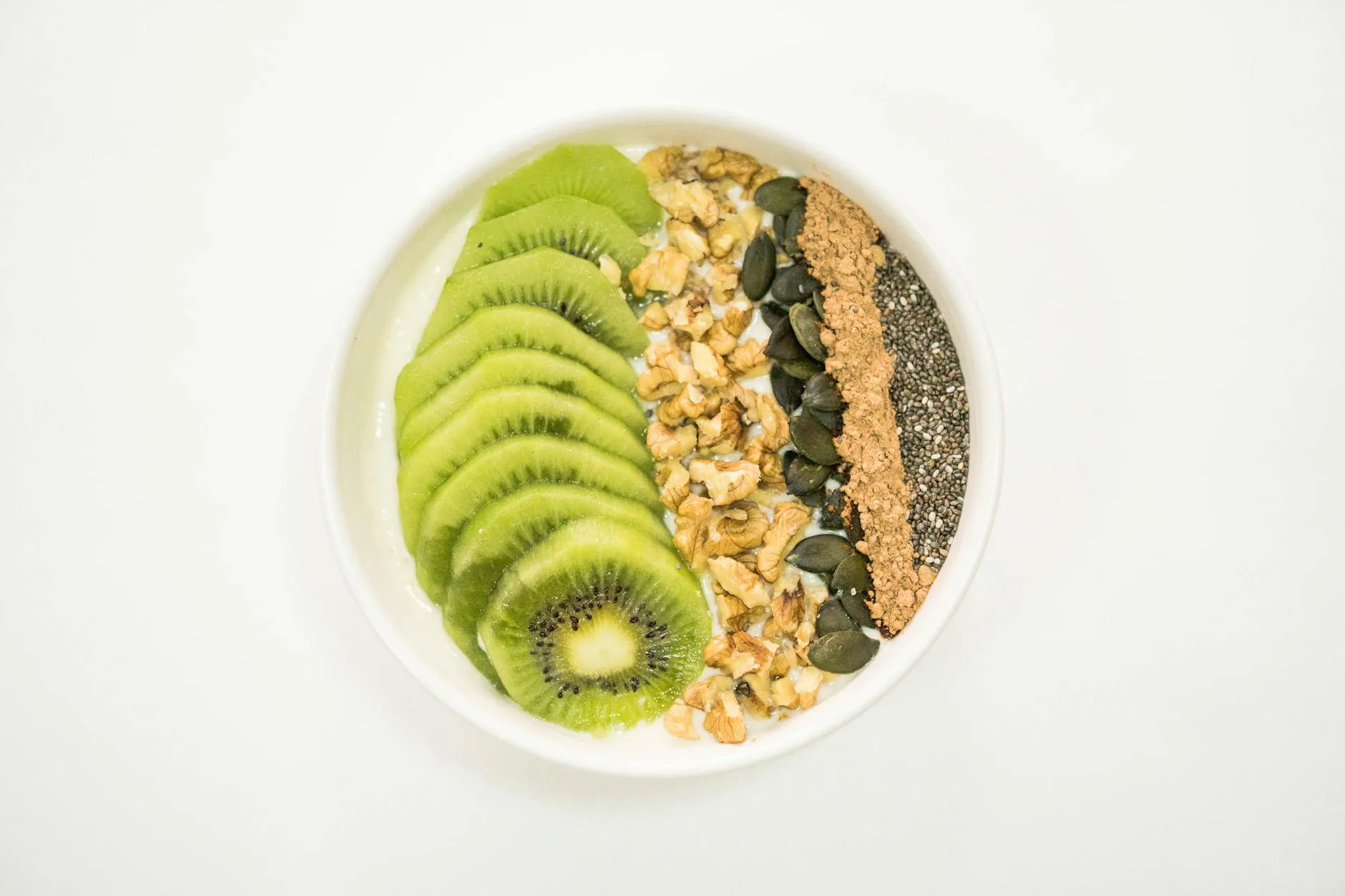 Smoothie bowl topped with fresh fruit and seeds