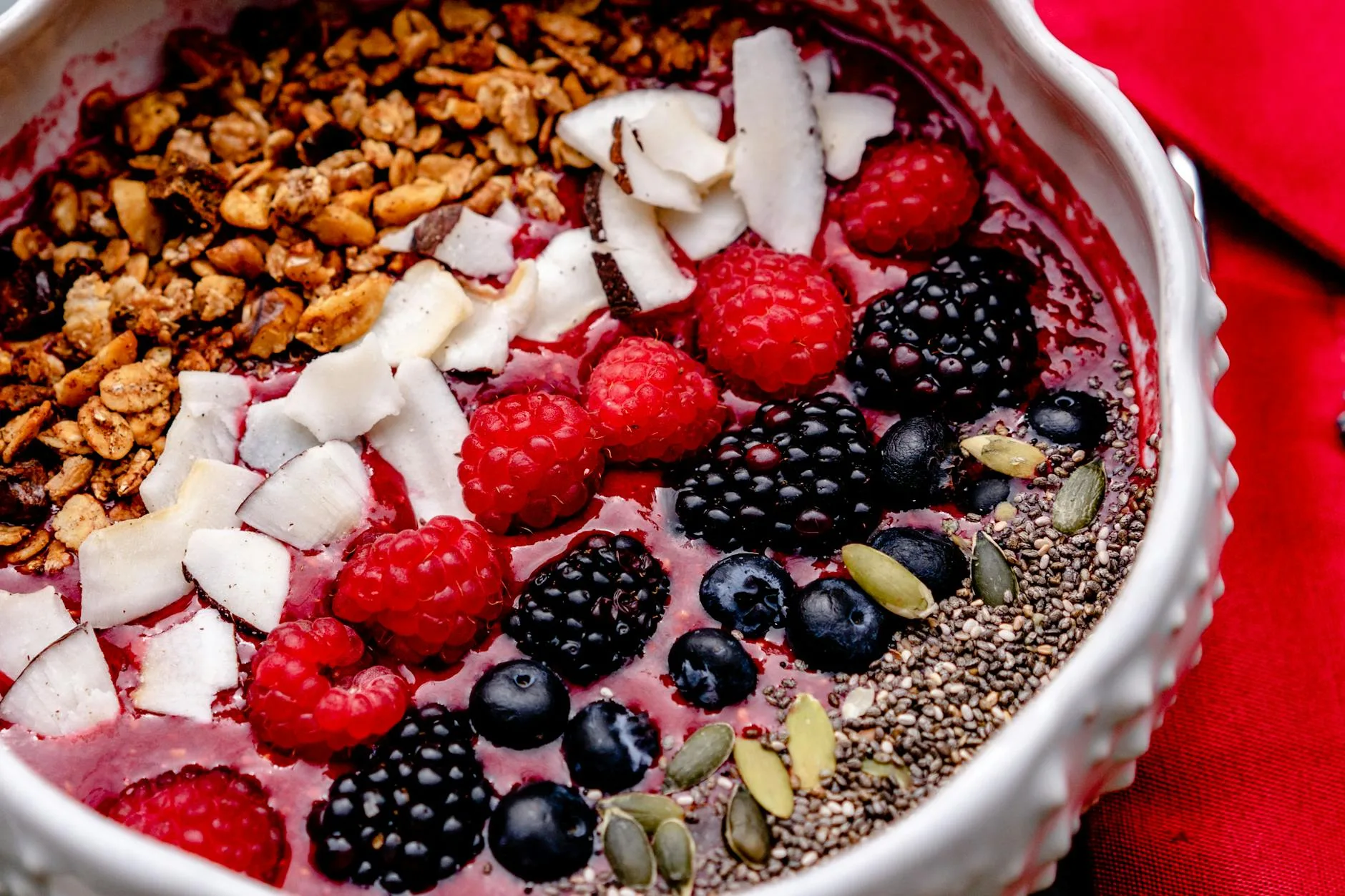 Thick smoothie bowl made with frozen berries served in a white bowl