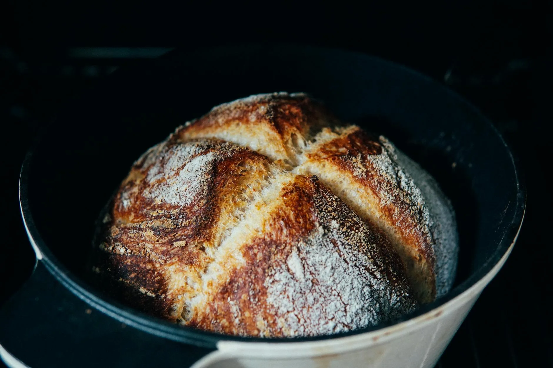 Fresh sourdough bread baked in a cast iron Dutch oven