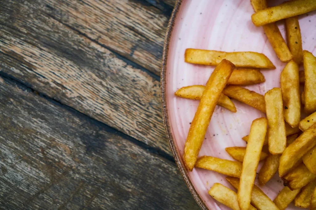 Crispy golden chips made in an air fryer served on a plate