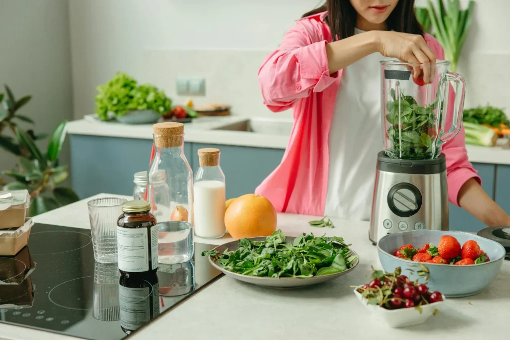 Personal blender making a fruit smoothie on a kitchen counter