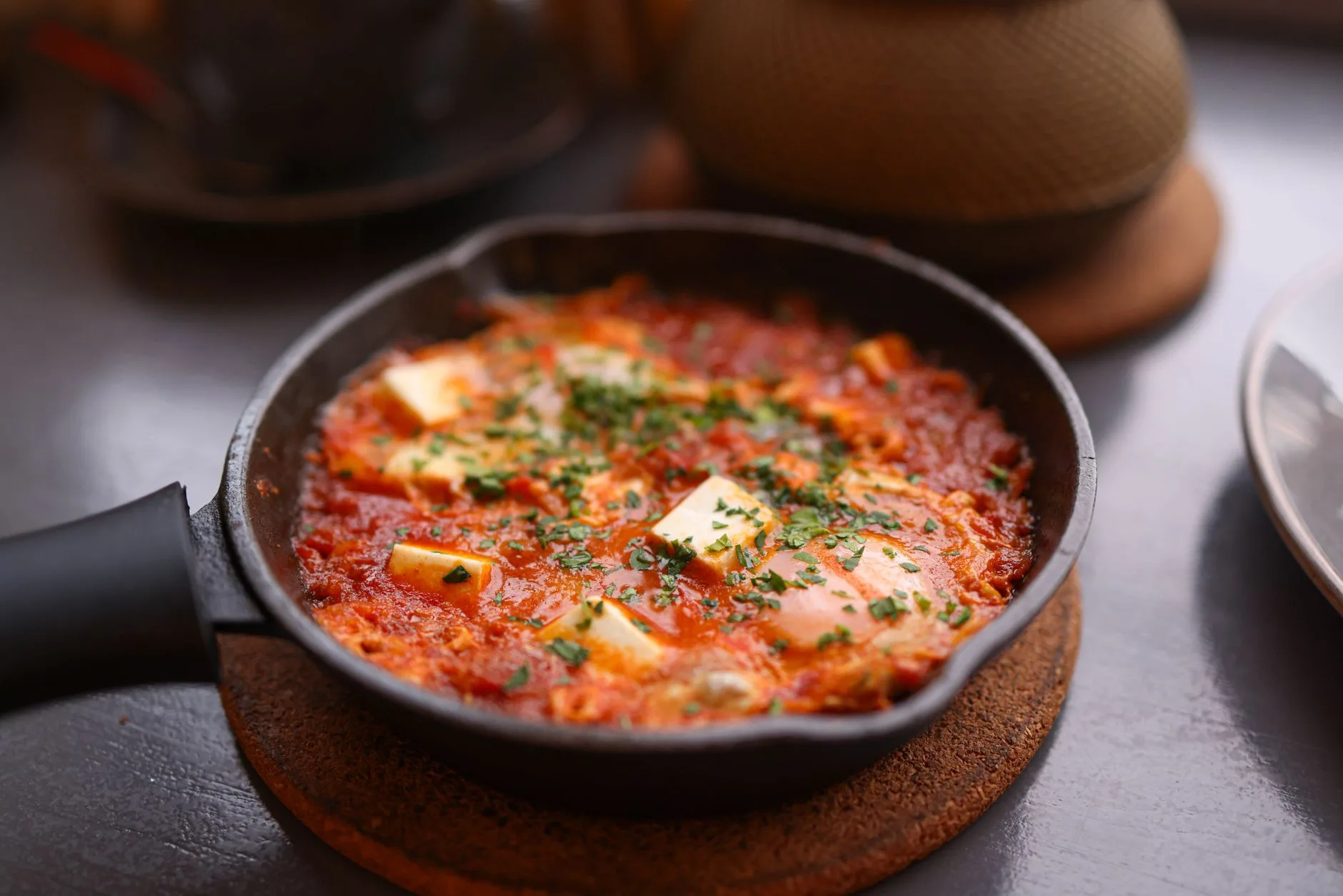 Cast iron pan with tomato one-pot meal ready to serve